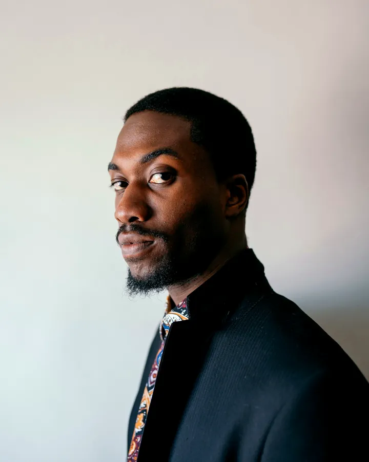 A founder in a dark suit jacket